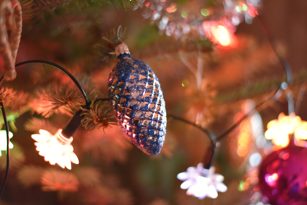 Blue christmas ornament on tree.