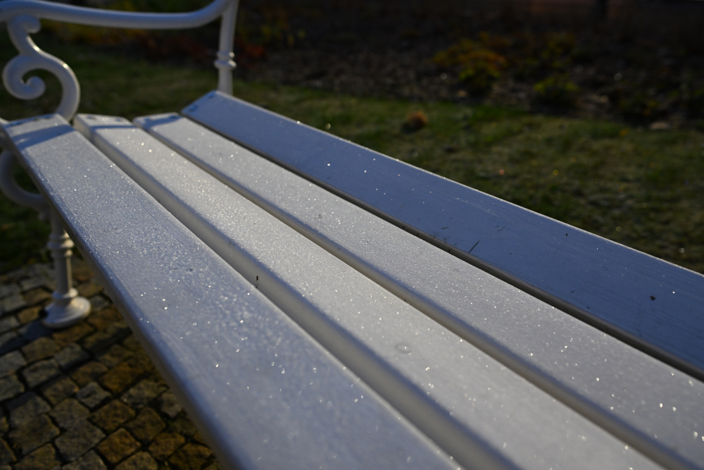 Frozen wooden bench Karlovy Vary in Christmass time.