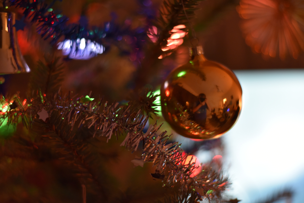 Orange christmas ornament on tree.